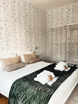 a bedroom with a large bed with towels on it at Twentythree Luxury Apartment in Rome