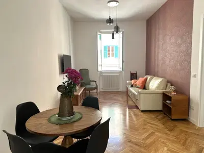a living room with a table and chairs and a couch at Bright House appartamento Roma in Rome