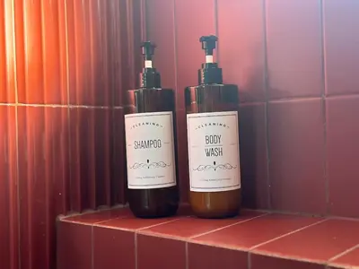 two bottles of wine sitting on a tile wall at Bright House appartamento Roma in Rome