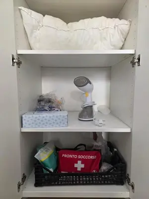 a shelf in a room with a bed and a pillow at Room Etruria Center Rome in Rome