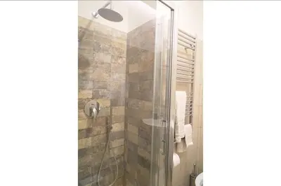 a bathroom with a shower with a glass door at Room Etruria Center Rome in Rome
