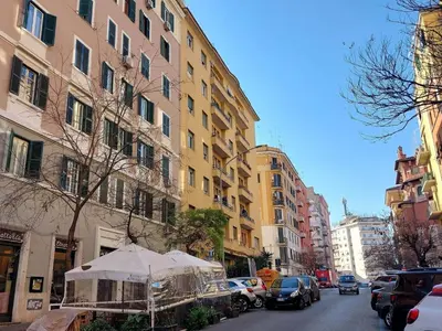 a city street with buildings and cars parked on the street at Room Etruria Center Rome in Rome