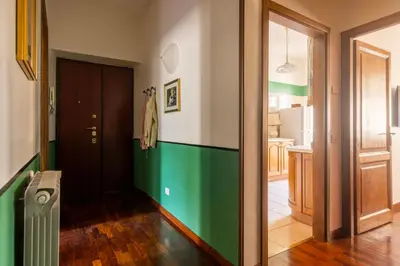 a hallway with a green and white stripe on the wall at The Magic of San Peter in the Heart of Rome in Rome