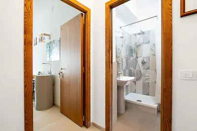 a bathroom with a sink and a toilet and a mirror at Vatican Cipro Guest House in Rome