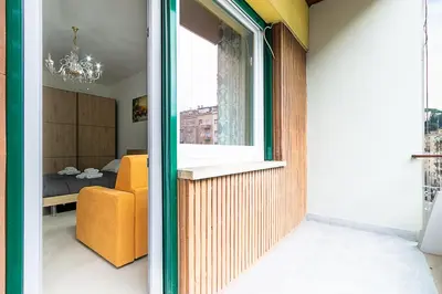 a living room with a window and a yellow chair at Vatican Cipro Guest House in Rome