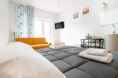 a bedroom with a large bed with towels on it at Vatican Cipro Guest House in Rome