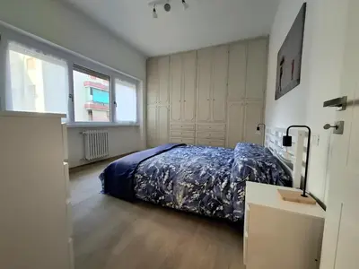 a bedroom with a bed with a blue blanket at DimorAlexis, the house in front of Vatican's walls in Rome