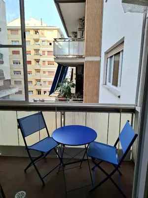 a blue table and two chairs on a balcony at DimorAlexis, the house in front of Vatican's walls in Rome