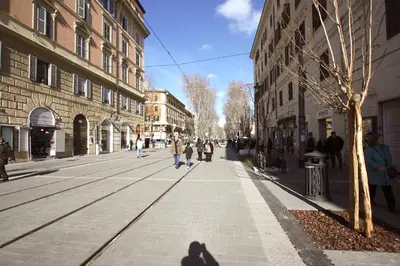 people walking down a street in a city with buildings at Ottaviano 2BR Holiday House in Rome
