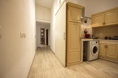 a kitchen with a washer and dryer in a room at Ottaviano 2BR Holiday House in Rome