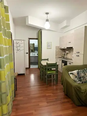 a living room with a couch and a table and a kitchen at Cute apartment next to vatican in Rome