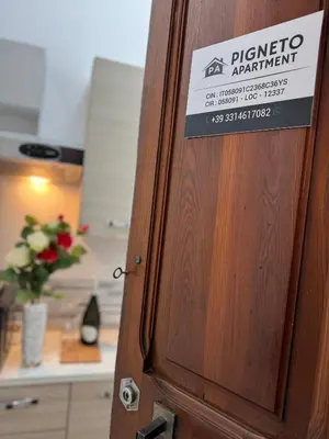 a sign on a wooden door with a sign on it at Piignetoo Apartment in Rome
