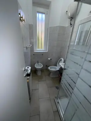a bathroom with a toilet and a sink at Piignetoo Apartment in Rome
