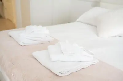 a pile of towels sitting on top of a bed at Saint Peter Beautiful 2BR Apartment in Rome
