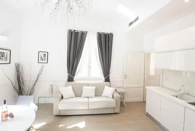 a white living room with a white couch and a sink at Saint Peter Beautiful 2BR Apartment in Rome