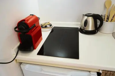 a counter top with a coffee pot and a tea kettle at 10 Min Città del Vaticano-Stadio olimpico Lucia Apartment 1BDR in Rome
