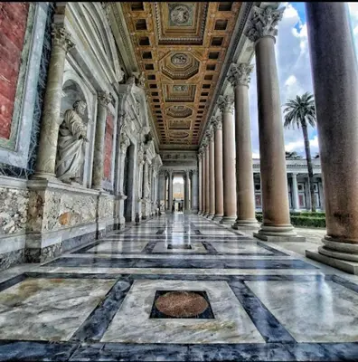 a hallway of a building with columns and a ceiling at 10 Minuti Stazione Trastevere - Atelier 19 1BDR by Hôtea in Rome
