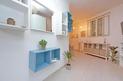 a living room with a blue cabinet and a sink at La corte di San Paolo by DomusDimore in Rome
