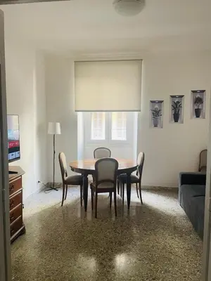 a dining room with a table and chairs and a couch at Antoni House San Giovanni in Rome