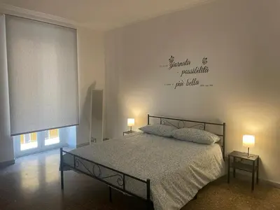 a bedroom with a bed with two lamps on it at Antoni House San Giovanni in Rome