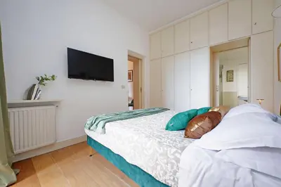 a bedroom with a bed with a television on the wall at Balcony al Colosseo by Luxury Getaways in Rome