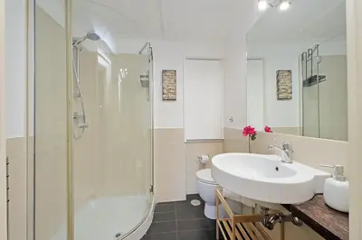 a bathroom with a sink and a shower and a toilet at Balcony al Colosseo by Luxury Getaways in Rome