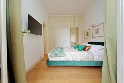 a bedroom with a bed and a television in it at Balcony al Colosseo by Luxury Getaways in Rome