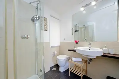 a bathroom with a sink and a toilet and a shower at Balcony al Colosseo by Luxury Getaways in Rome