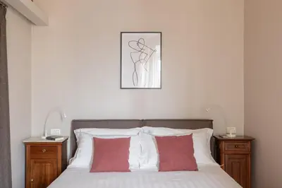 a bedroom with a bed with red and white pillows at HospitalityRome Doninzetti 20 in Rome