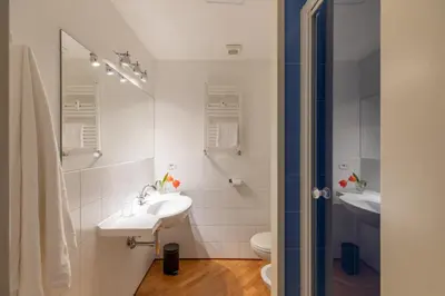a white bathroom with a sink and a toilet at HospitalityRome Doninzetti 20 in Rome