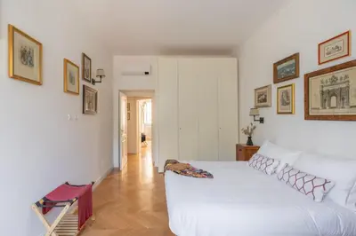 a bedroom with a large white bed in a room at iFlat Charming & Spacious Flat in Trastevere in Rome