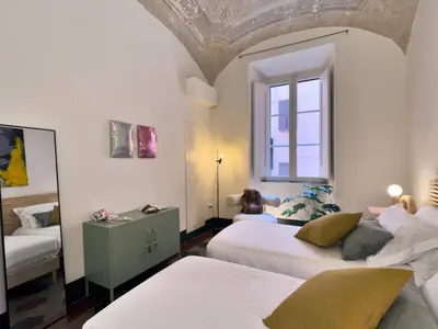 a bedroom with two beds and a window at La Casa al Colosseo in Rome