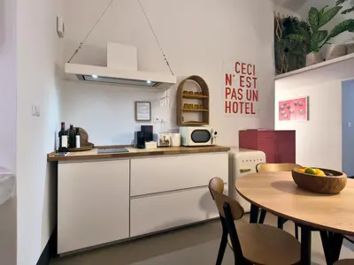 a kitchen with a wooden table and a dining room at La Casa al Colosseo in Rome
