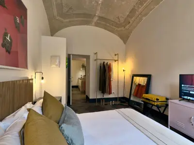 a bedroom with a bed with a ceiling at La Casa al Colosseo in Rome