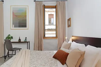 a bedroom with a bed and a desk and a window at Trastevere Historic Loft by Luxury Getaways in Rome