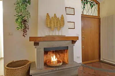 a fireplace with candles in a living room at Trastevere Historic Loft by Luxury Getaways in Rome