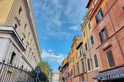 a city street with buildings and a blue sky at Trastevere Historic Loft by Luxury Getaways in Rome