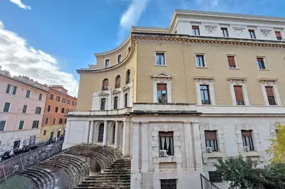 a building with a spiral staircase in front of it at Trastevere Historic Loft by Luxury Getaways in Rome