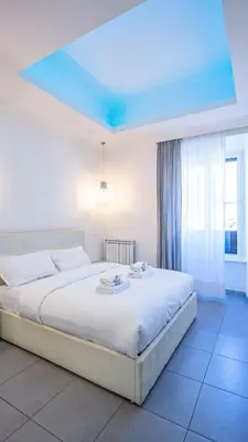 a bedroom with a large bed with a blue ceiling at EasyTopStay - Stylish Vatican Retreat in Rome