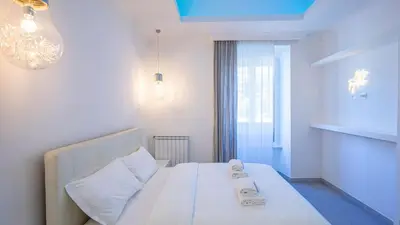 a bedroom with a white bed and a window at EasyTopStay - Stylish Vatican Retreat in Rome