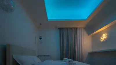 a bedroom with a large projection screen on the ceiling at EasyTopStay - Stylish Vatican Retreat in Rome