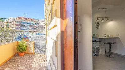 a room with a balcony with a view of a building at EasyTopStay - Stylish Vatican Retreat in Rome