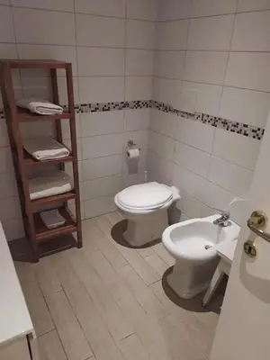 a bathroom with a toilet and a sink at Garbatella seminterrato in Rome