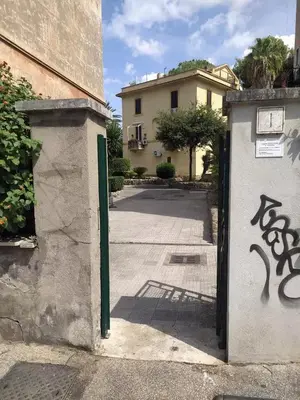 a gate to a building with graffiti on it at Garbatella seminterrato in Rome