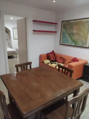 a living room with a table and a couch at Garbatella seminterrato in Rome