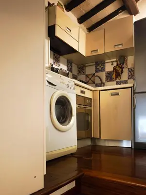 a kitchen with a washing machine in a kitchen at Piccolo Attico in Rome