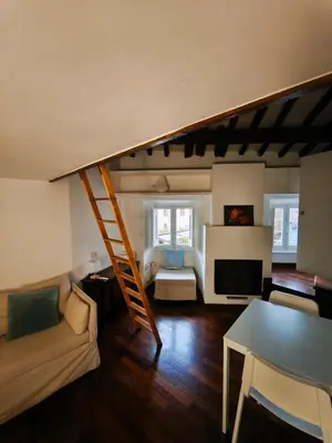 a living room with a staircase leading to a living room at Piccolo Attico in Rome