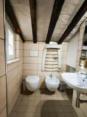 a bathroom with two sinks and a toilet at Piccolo Attico in Rome