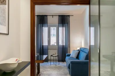 a living room with a blue couch and a table at Casa Laberio by Hili in Rome