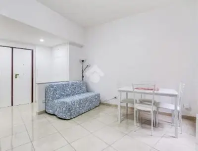 a living room with a couch and a table and a chair at Casa Vulture in Rome